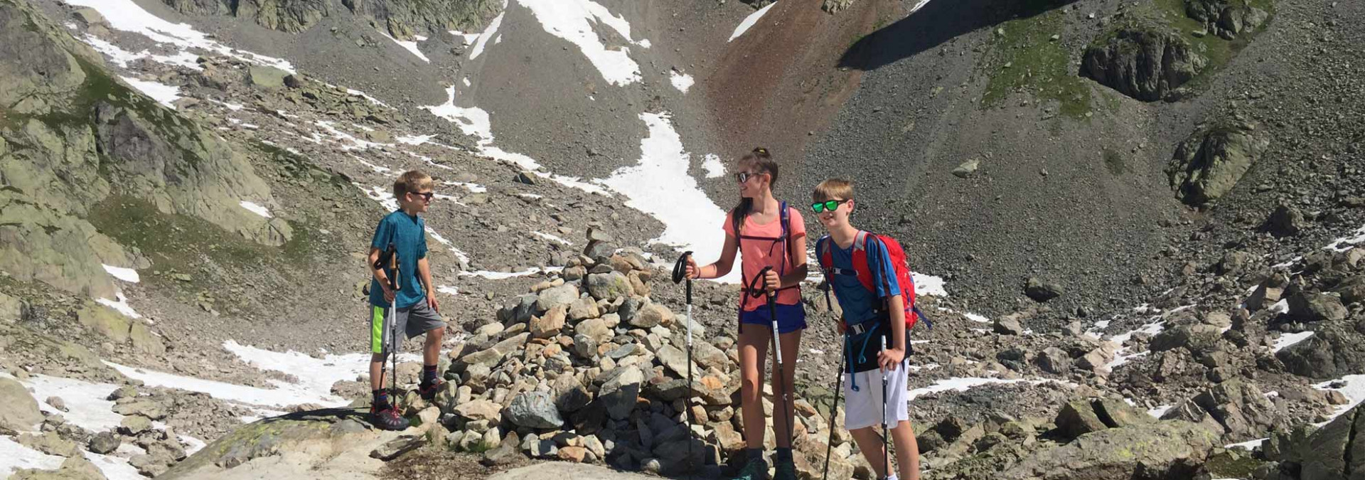 Family Tour du Mont Blanc - pausing by a cairn near the col du Bonhomme, France